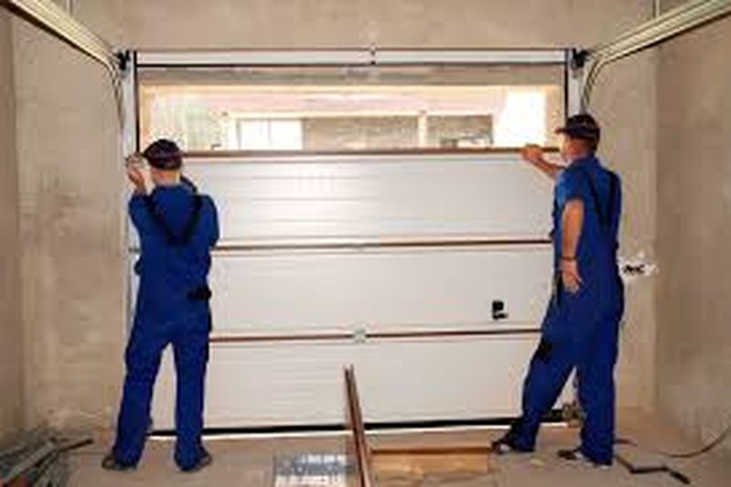Licensed and insured M&M garage door technicians in uniform on a residential install
